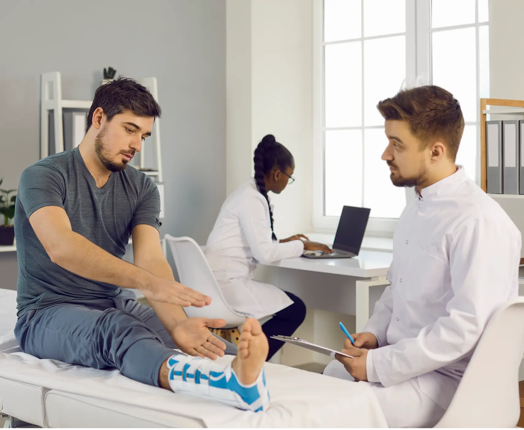 Patient consulting doctor about foot injury.